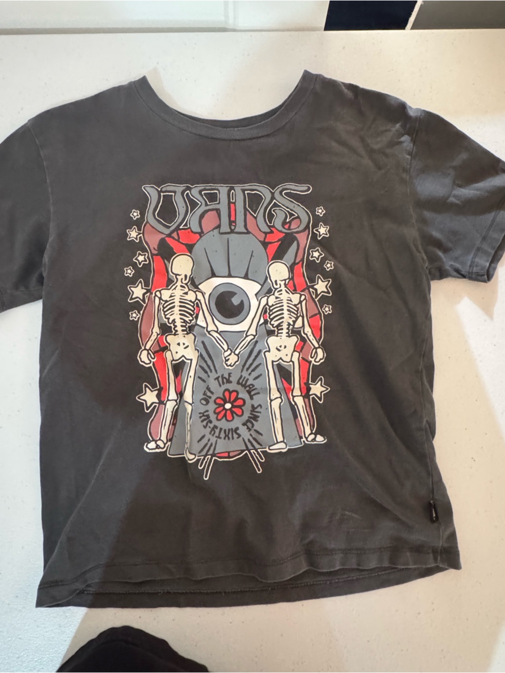Vans Black Graphic Tee with Red and White Skull Design